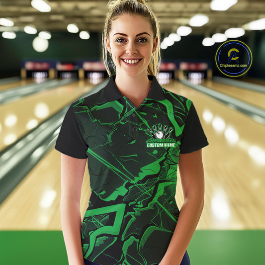 Female model wearing a black and green bowling polo in a bowling lane with cracked geometric artwork.