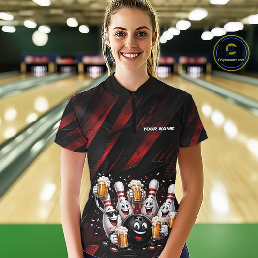 Female model shown from the front wearing a black and red bowling quarter zip shirt featuring festive cartoon bowling balls and pins raising frothy beer mugs with confetti and bold diagonal stripes in a bowling lane.