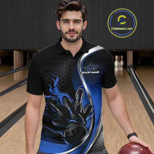 Male model seen from the front in a bowling lane wearing a black and blue polo shirt featuring a flame bowling ball striking pins in a dynamic sports scene.