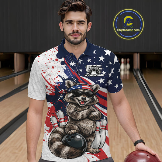 Male model in a bowling lane wearing a bowling polo with patriotic raccoon artwork leaning against a bowling ball.