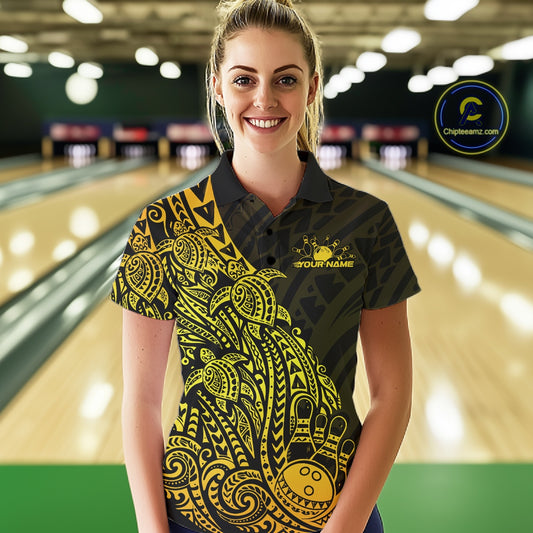 Female model wearing a black and gold bowling polo shirt at the bowling lane with turtle-themed tribal bowling graphics.