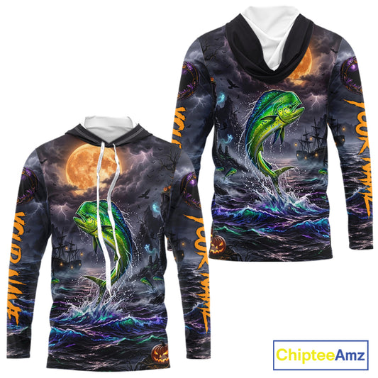 A long-sleeve hooded sweatshirt shown from the front and back, featuring an all-over Halloween-themed graphic print with a green fish jumping from dark ocean waves under a full moon, plus orange text down the sleeves. The hoodie has a black hood and white drawstrings.