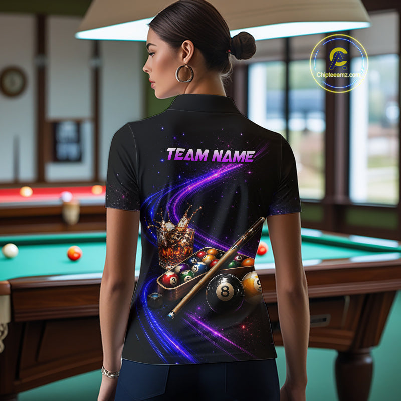 A woman stands in a billiards room wearing a black short-sleeve polo shirt with a vibrant purple and blue graphic print on the back featuring pool balls, a cue stick, and the text 'TEAM NAME'.