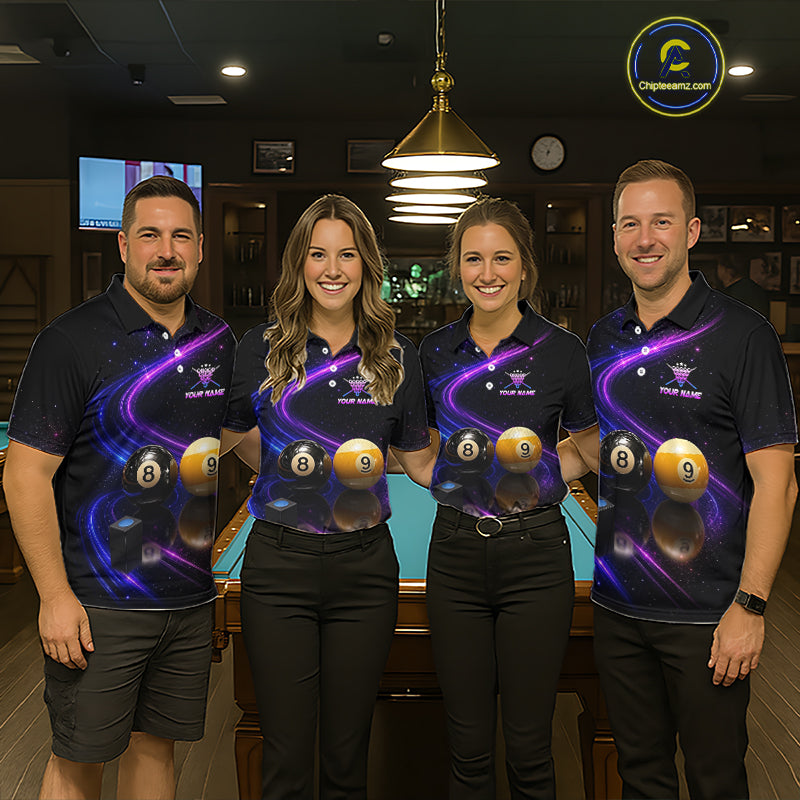Four people standing together in a dimly lit indoor venue, wearing matching dark navy polo shirts with a purple cosmic billiards graphic featuring 8-ball and 9-ball designs. The background shows a pool table and warm hanging lights.