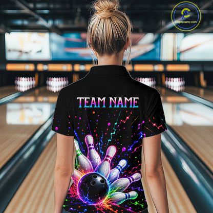 Person wearing a black bowling shirt with colorful design and 'TEAM NAME' text in a bowling alley.