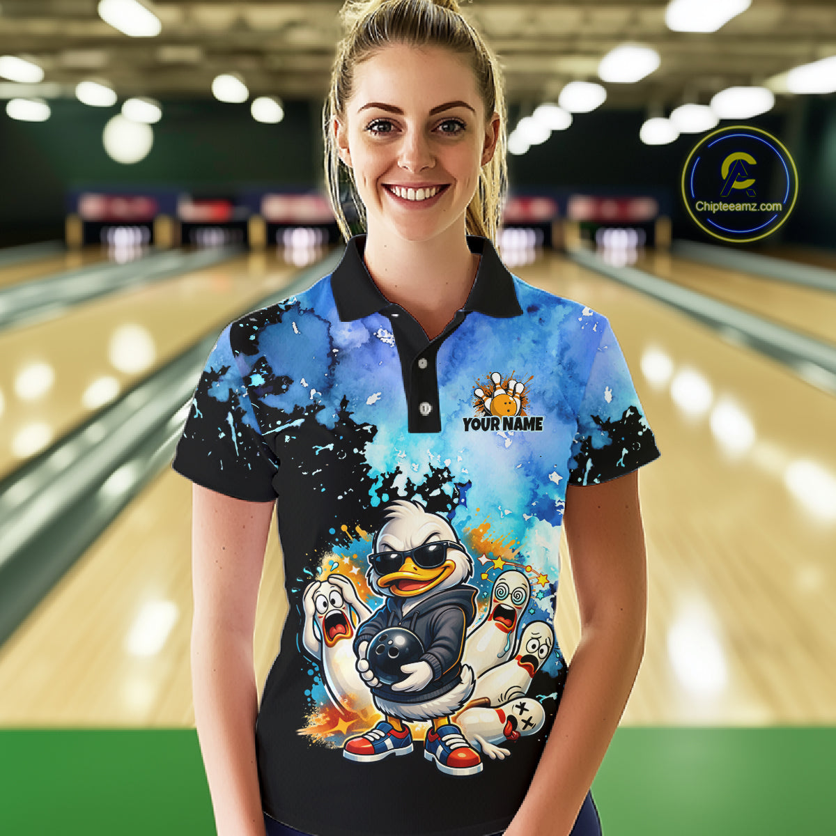 Woman wearing a colorful bowling shirt with cartoon characters in a bowling alley.