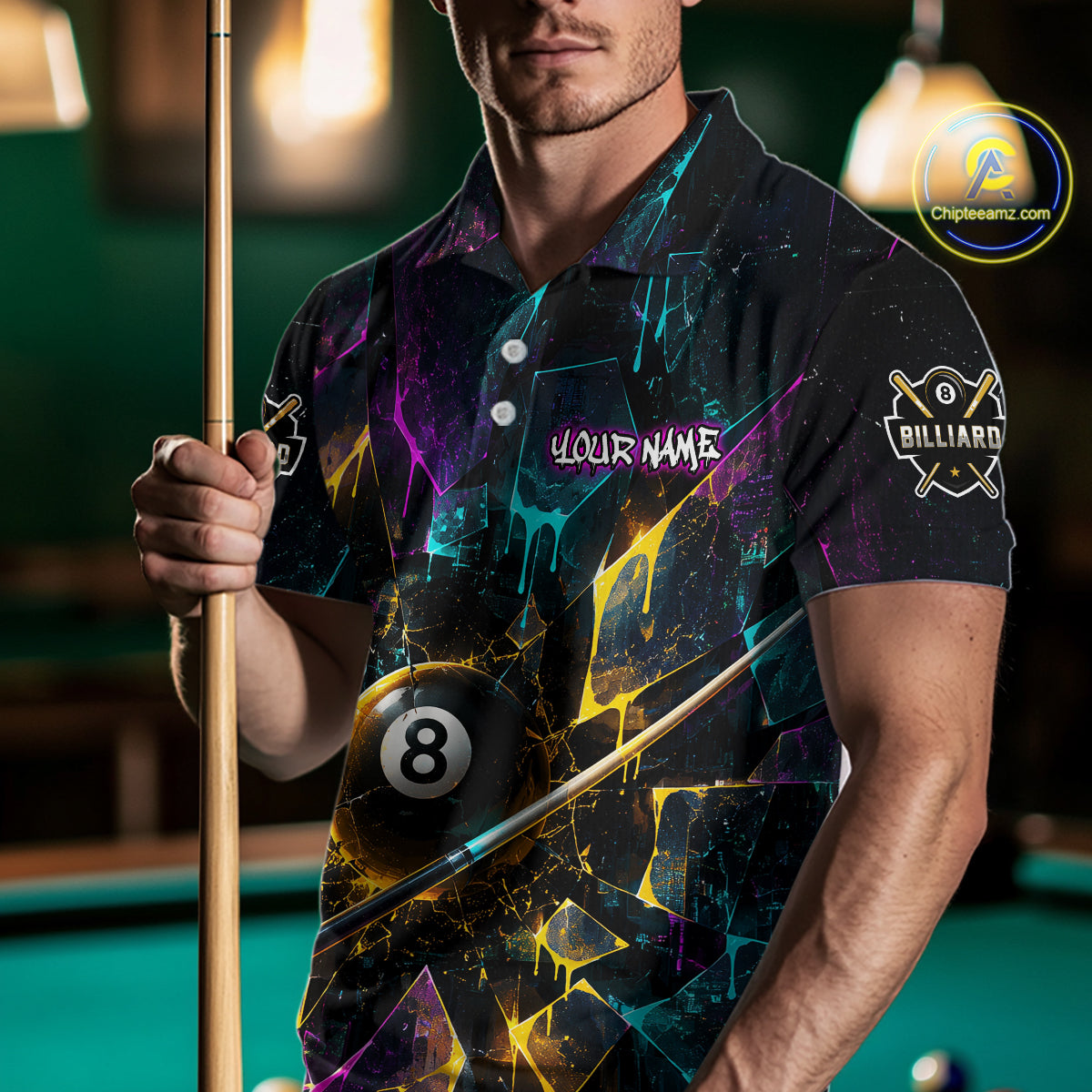 Man wearing custom colorful shattered glass 8 ball billiard polo shirt standing at a pool table holding a cue stick in a billiard room