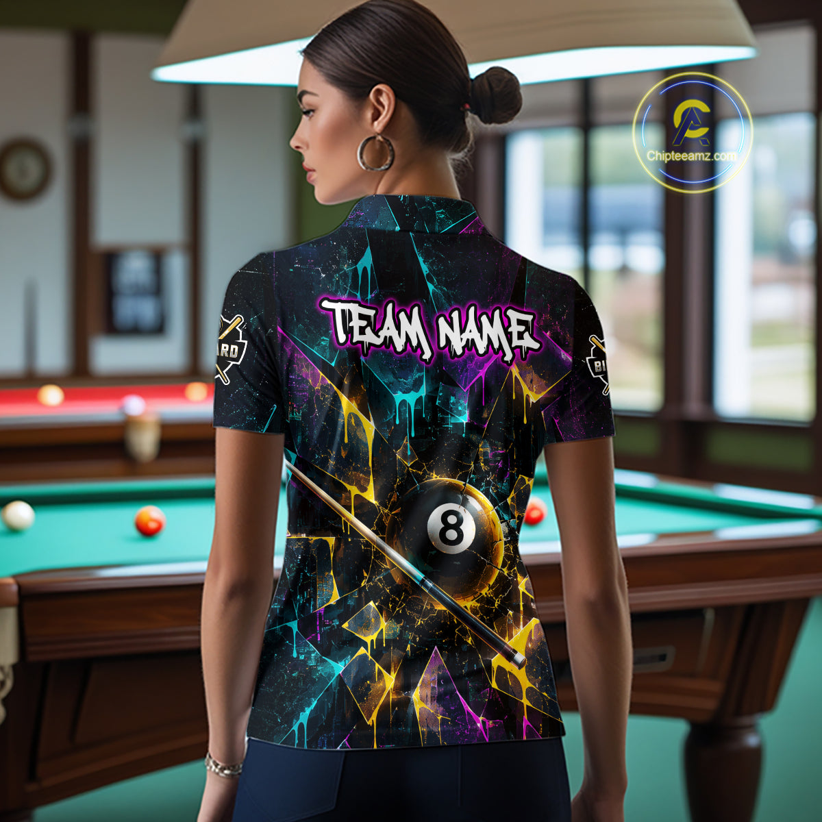 Back view of woman wearing custom colorful shattered glass 8 ball billiard polo shirt in a billiard room showing personalized team name