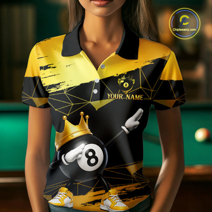 Woman wearing custom black and gold geometric crown 8 ball billiard polo shirt standing at a pool table in a billiard room