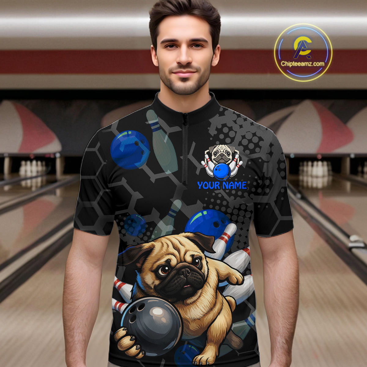 Man wearing a black bowling-themed shirt with a pug design in a bowling alley.