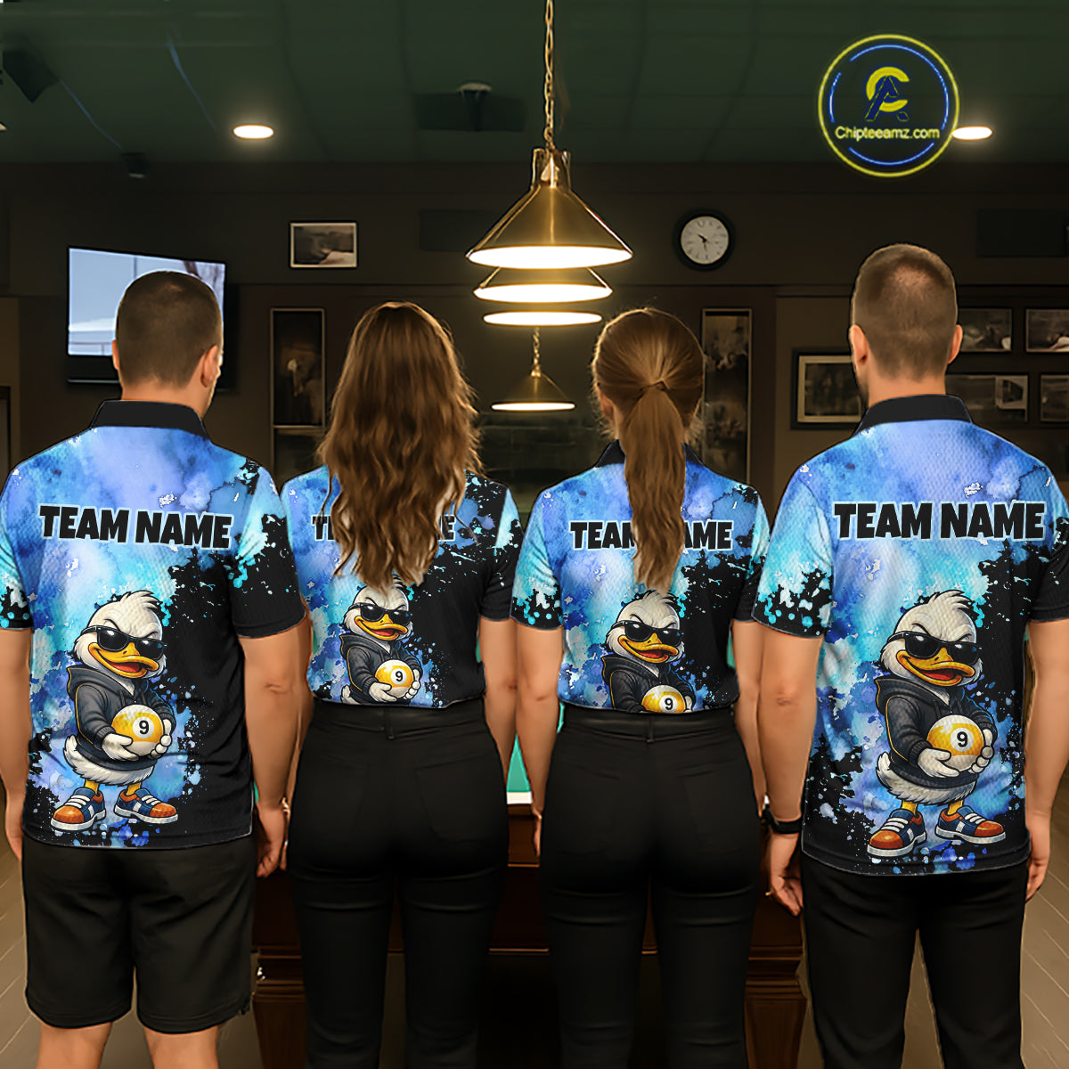 Four people standing with their backs to the camera in a dimly lit indoor room, wearing matching custom team polo shirts featuring a cartoon duck character holding billiard ball and the text 'TEAM NAME'.