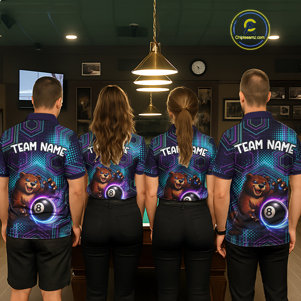 Four people wearing matching bowling shirts with a bear and ball design in a bowling alley.