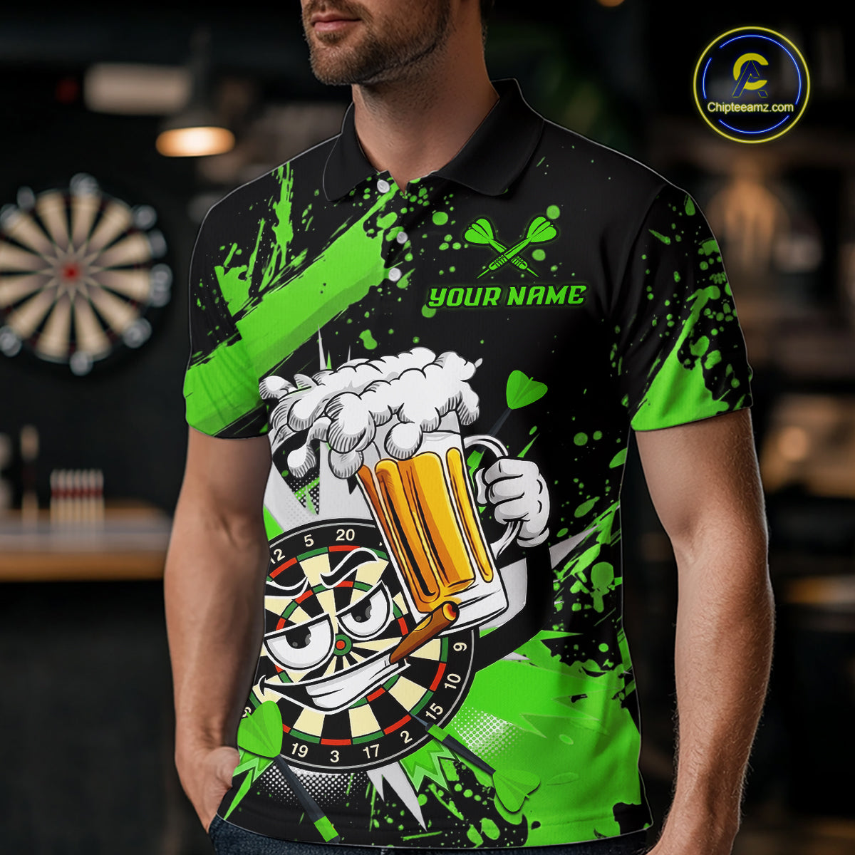 A man wearing a black and neon green short-sleeve polo shirt with a darts and beer-themed graphic print. The shirt features a cartoon dartboard face, a foaming beer mug, crossed darts, and the text 'YOUR NAME' on the chest.