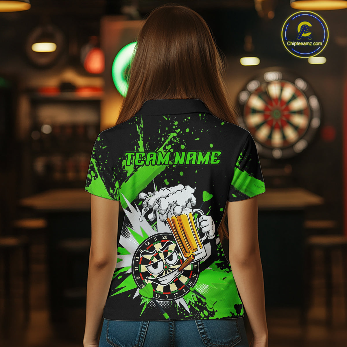A woman viewed from behind wearing a black short-sleeve polo shirt with a bright green and white graphic print featuring a cartoon dartboard holding a beer mug and the text 'TEAM.NAME'.