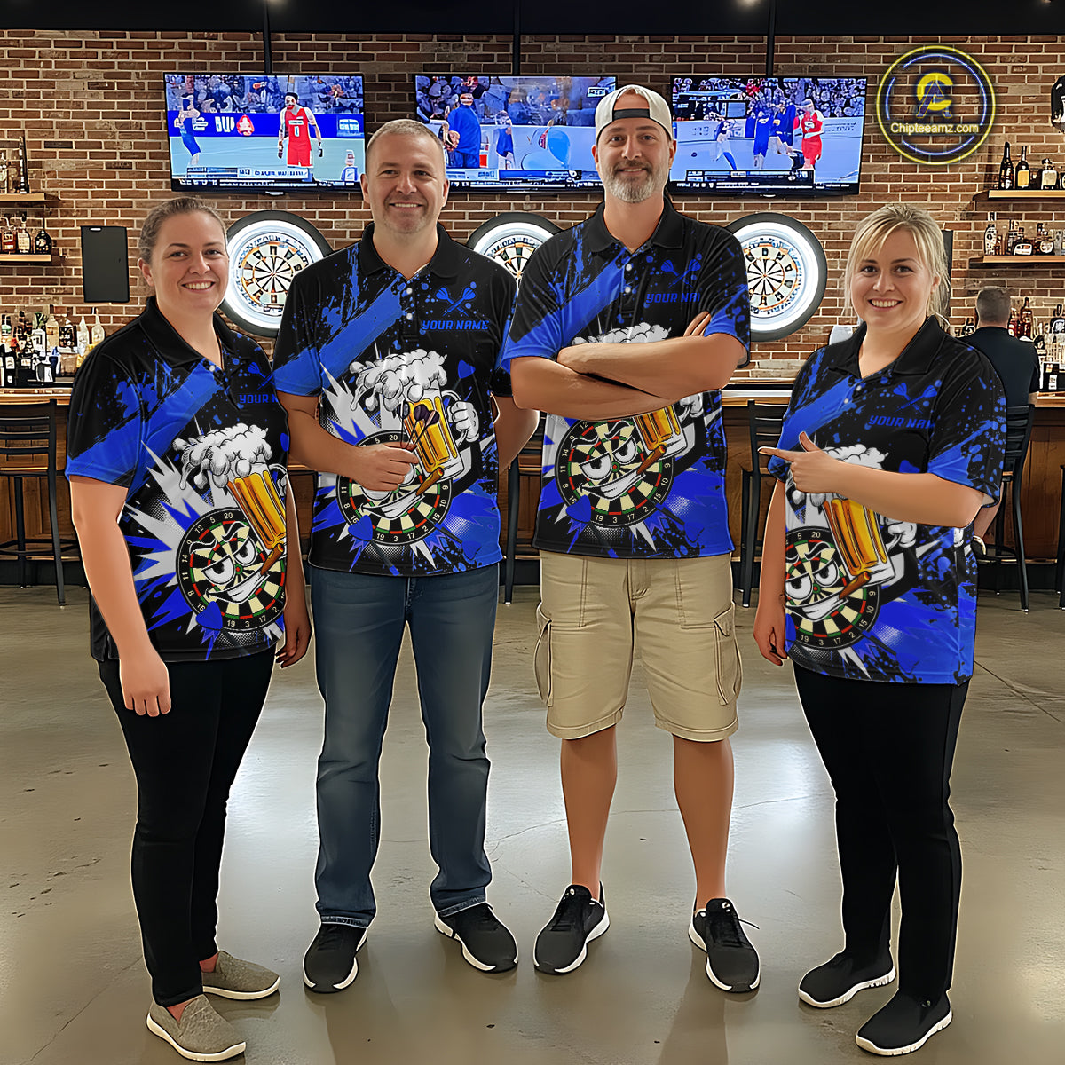 Four people standing together in a bar wearing matching blue and black sports-themed short-sleeve shirts with a large graphic print featuring a basketball, trophy, and dartboard elements.