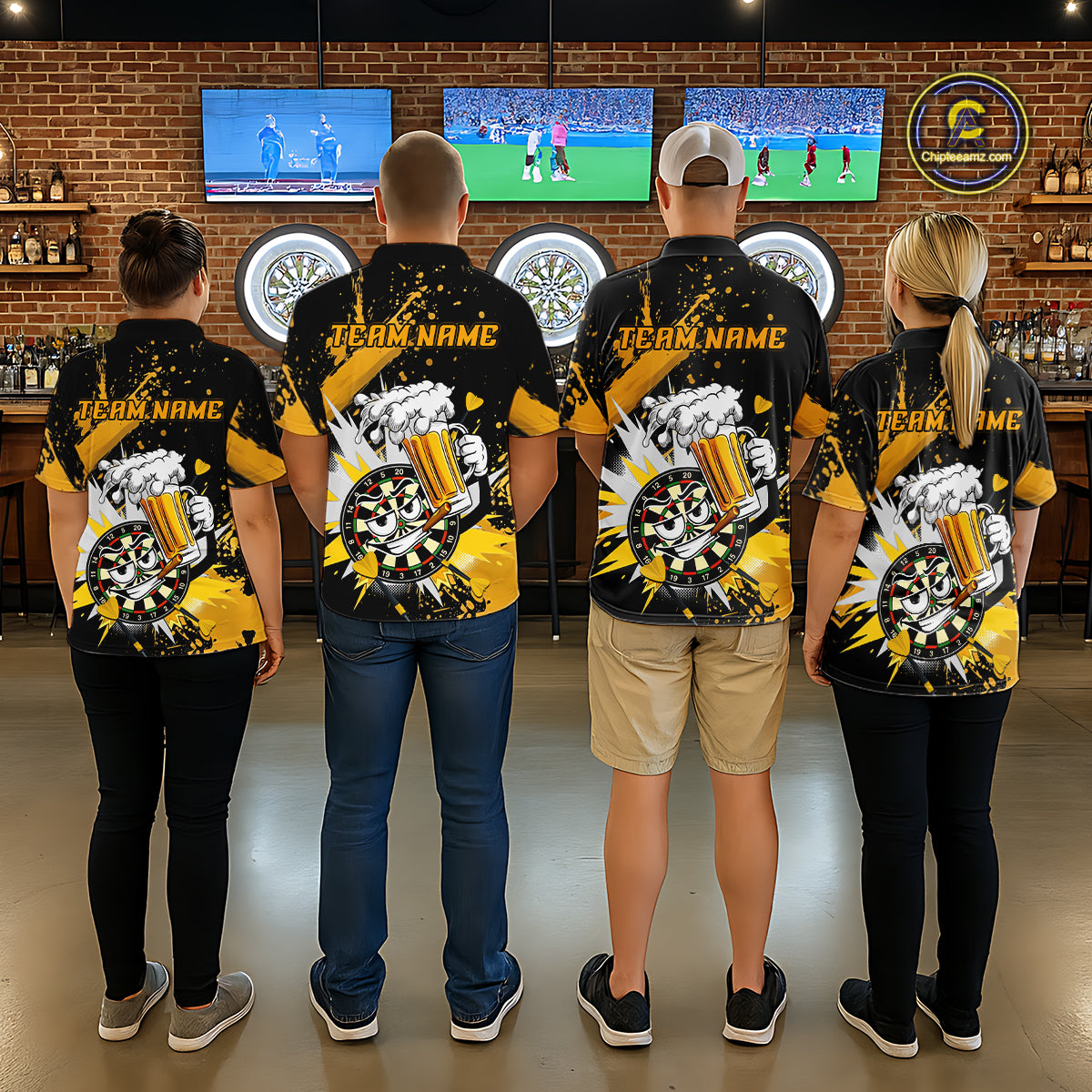 Four people standing with their backs to the camera in a bar-like environment, wearing matching black and yellow custom team shirts with a dartboard and beer mug graphic and 'TEAM NAME' printed on the back.