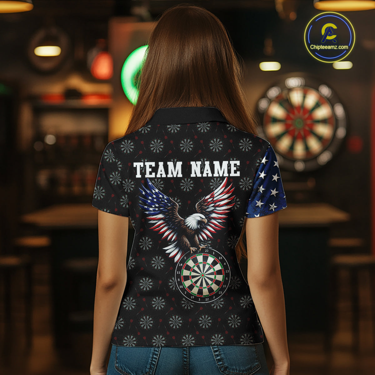 Back view of a female model showing off a patriotic darts shirt, featuring a striking bald eagle and dartboard graphic along with a customizable team name.