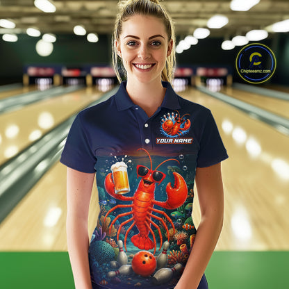 Person wearing a navy blue polo shirt with a colorful lobster design in a bowling alley.