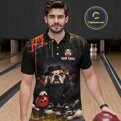 A man wearing custom black bulldog bowling polo shirt front view featuring a fierce cartoon mascot, bowling ball and paint drip effect, displaying Your Name, at the bowling alley
