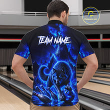 Load image into Gallery viewer, Person wearing a black t-shirt with a blue wolf design and 'TEAM NAME' text on the back, standing in a bowling alley.
