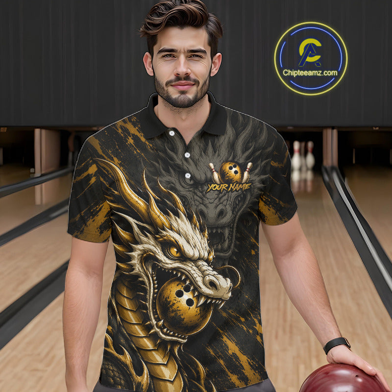 A man wearing a black and gold bowling-themed polo shirt with a large dragon graphic and a bowling pin logo, standing in a bowling alley. 