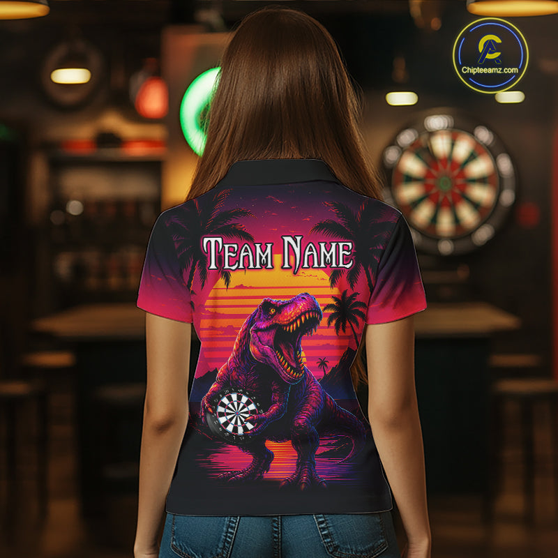 Women wearing darts polo shirt featuring a dinosaur holding a dartboard with sunset and palm tree artwork on a colorful background.