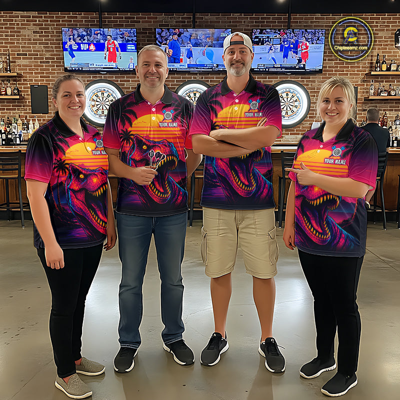 Four people wearing darts polo shirt featuring a dinosaur holding a dartboard with sunset and palm tree artwork on a colorful background