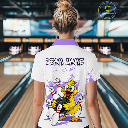 A woman viewed from behind wearing a white bowling-themed polo shirt with a purple collar and a large cartoon duck graphic on the back. The shirt features the text 'TEAM NAME' and a bowling scene with pins, bowling balls, and purple paint splatters.