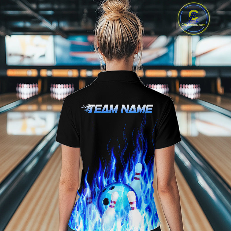 Person wearing a black bowling shirt with blue flames and 'Team Name' text in a bowling alley.