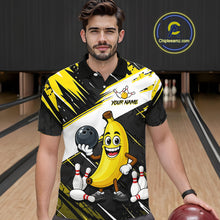Load image into Gallery viewer, Man wearing a bowling-themed shirt with a cartoon banana character in a bowling alley.