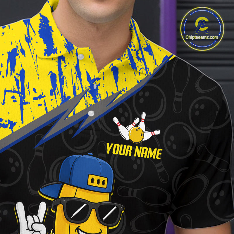 Man wearing a black shirt with a yellow and blue design, featuring a cartoon character and text.