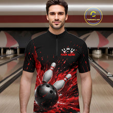 Load image into Gallery viewer, Man wearing a black bowling quarter zip shirt with dramatic red splatter graphics, a large black bowling ball, and flying pins, plus custom player name text.