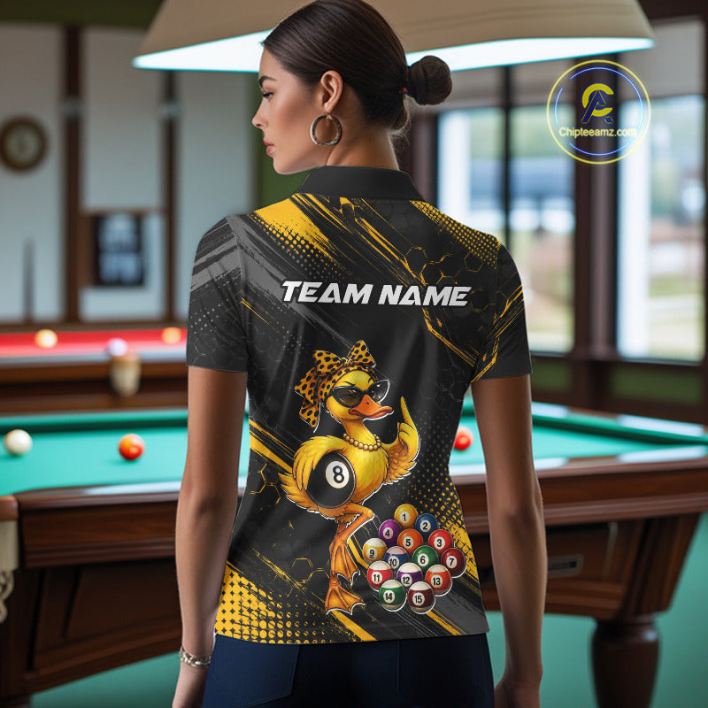 Women wearing billiards polo shirt featuring a duck holding an eight ball with pool balls arranged across a black yellow background.
