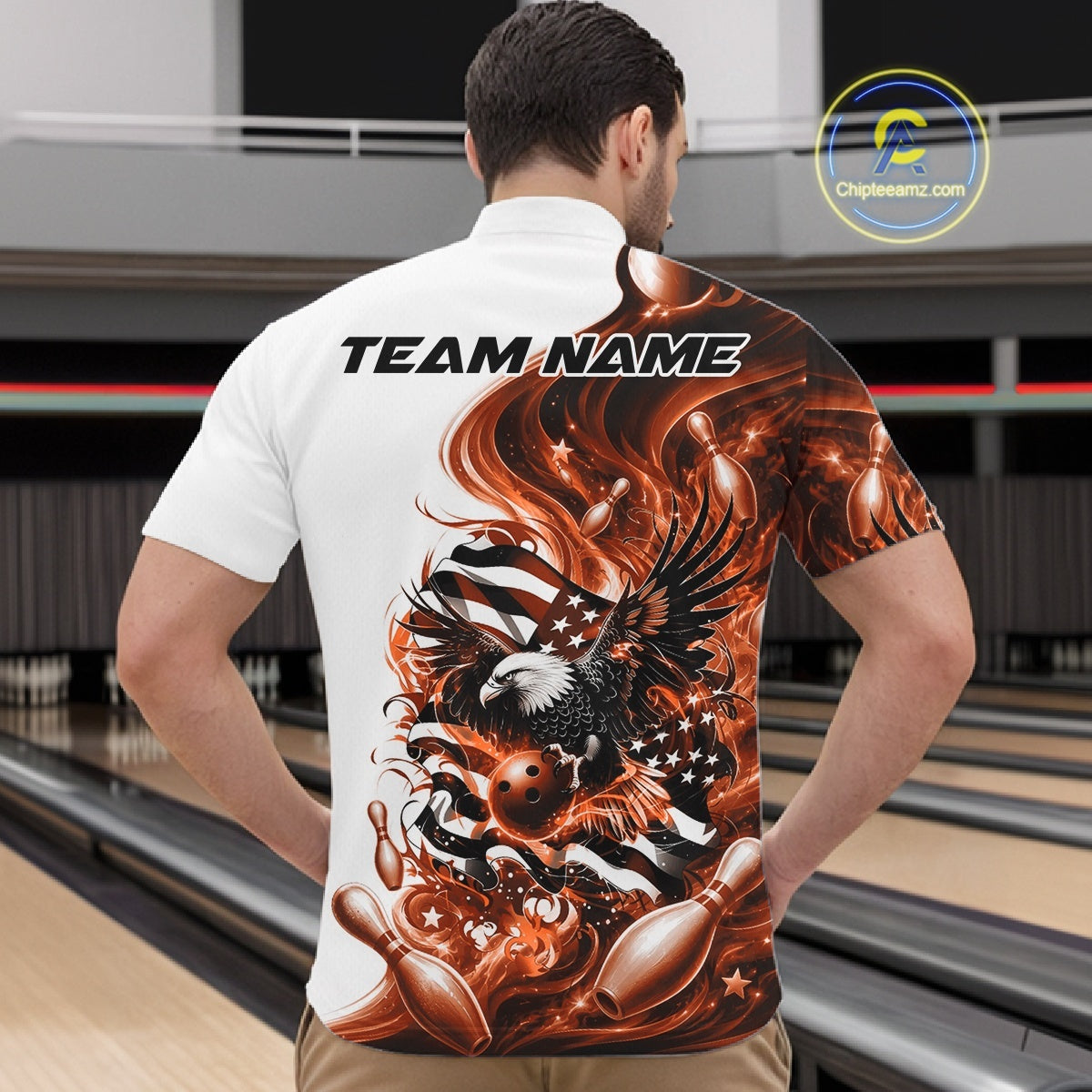 Male model front view at the bowling lane wearing a white and orange bowling quarter zip shirt with eagle artwork and flag inspired accents.