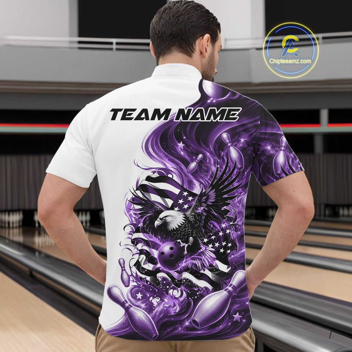 Male model front view at the bowling lane wearing a white and purple bowling quarter zip shirt with eagle artwork and flag inspired accents.