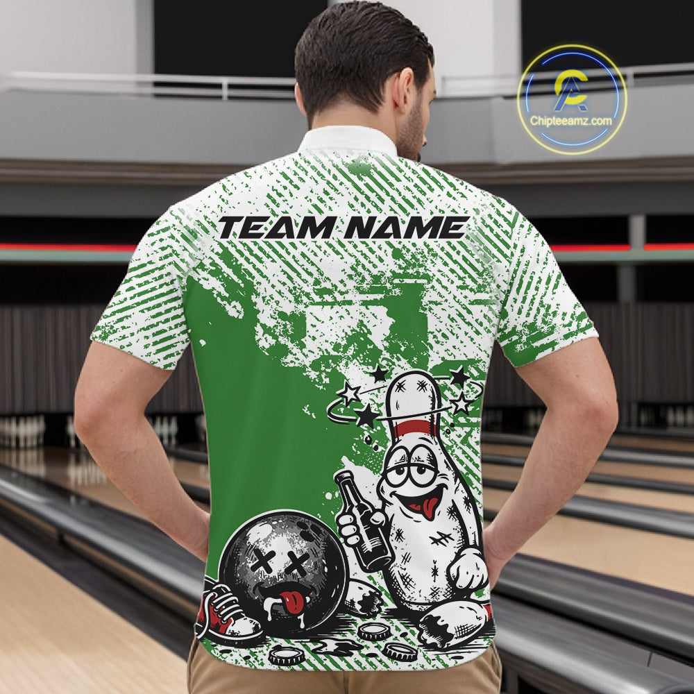 Male model at a bowling lane wearing a green and white quarter-zip shirt, cartoon drunk bowling pin with beer bottle and bowling ball graphic.