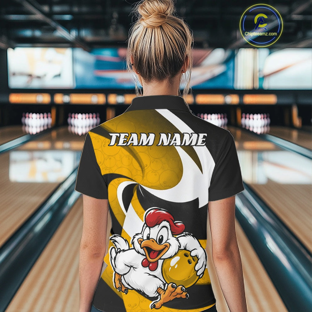A woman viewed from behind wearing a custom bowling-themed short-sleeve polo shirt with a cartoon chicken graphic and 'TEAM NAME' text, set against a blurred bowling alley background.