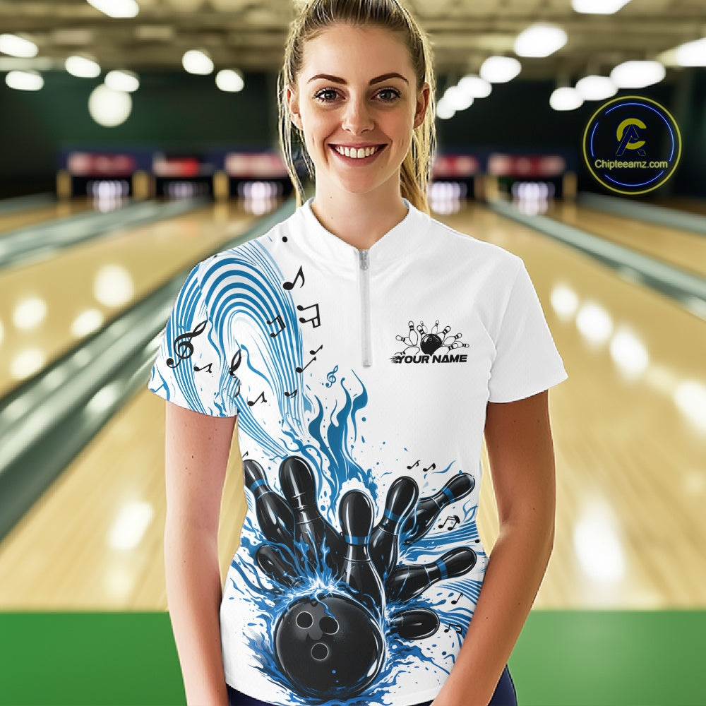 Female model in a white and blue bowling quarter-zip shirt at the lane with bowling-themed graphics and flowing musical accents.
