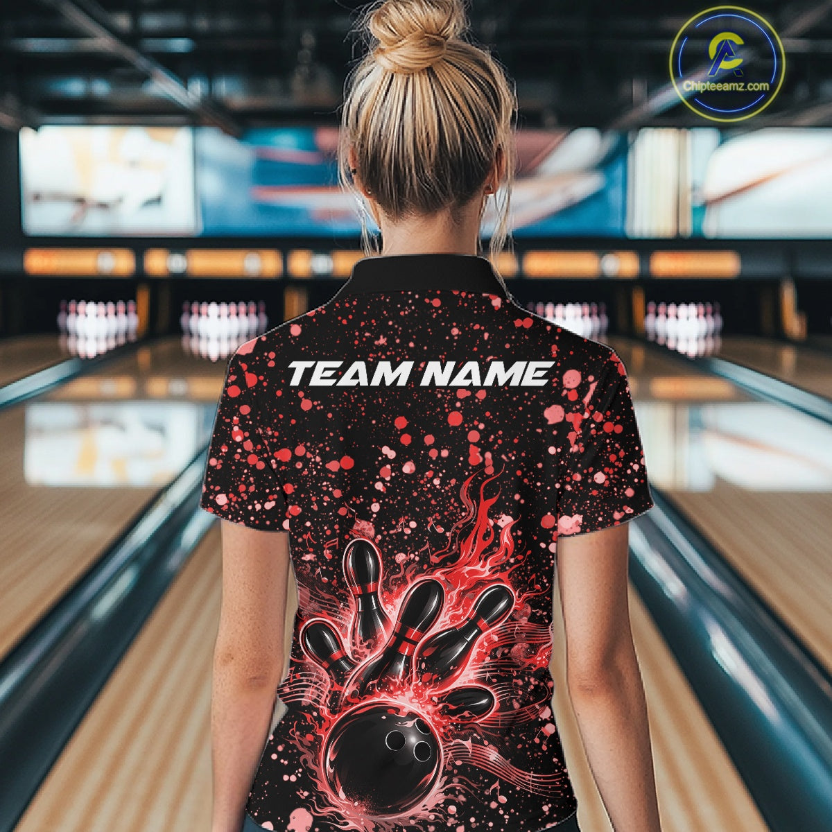 Back view of a female model in a black bowling polo shirt displaying fiery bowling artwork and red music-themed accents.