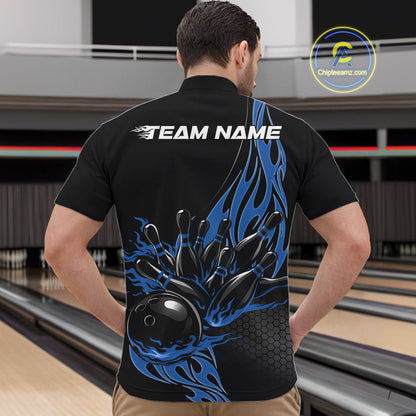 At the bowling lane, front view male model wearing black quarter zip shirt featuring blue flame bowling ball striking pins in energetic sports design.