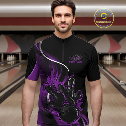 Male model front view inside bowling venue wearing black and purple quarter zip shirt featuring flame bowling action illustration