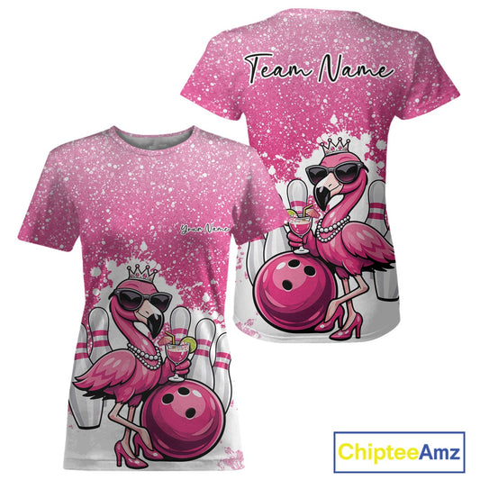 Pink women’s crewneck bowling T-shirt shown from the front and back with a crowned flamingo holding a cocktail beside a bowling ball on a paint splatter backdrop.
