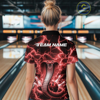 Back view of a womens bowling polo showcasing a red cobra wrapped around a bowling ball with lightning effects.