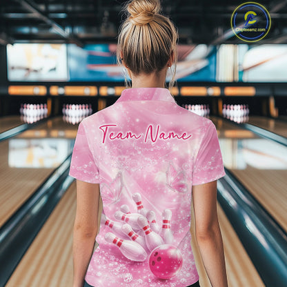 Back view of a female model at a bowling alley wearing a pink quarter zip shirt featuring bowling strike artwork with butterflies.