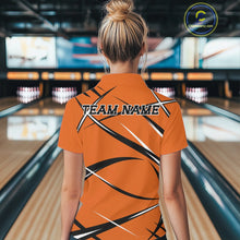 Load image into Gallery viewer, Back view of a female model wearing an orange, black, and white bowling polo shirt in a bowling lane