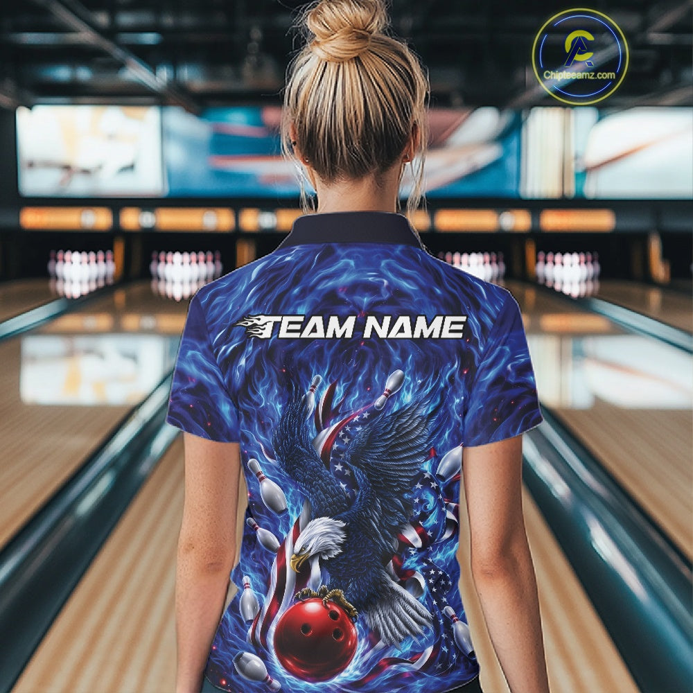 Back view female model in a bowling lane wearing a bowling polo shirt with eagle artwork, bowling ball, flowing flag elements, and pins.