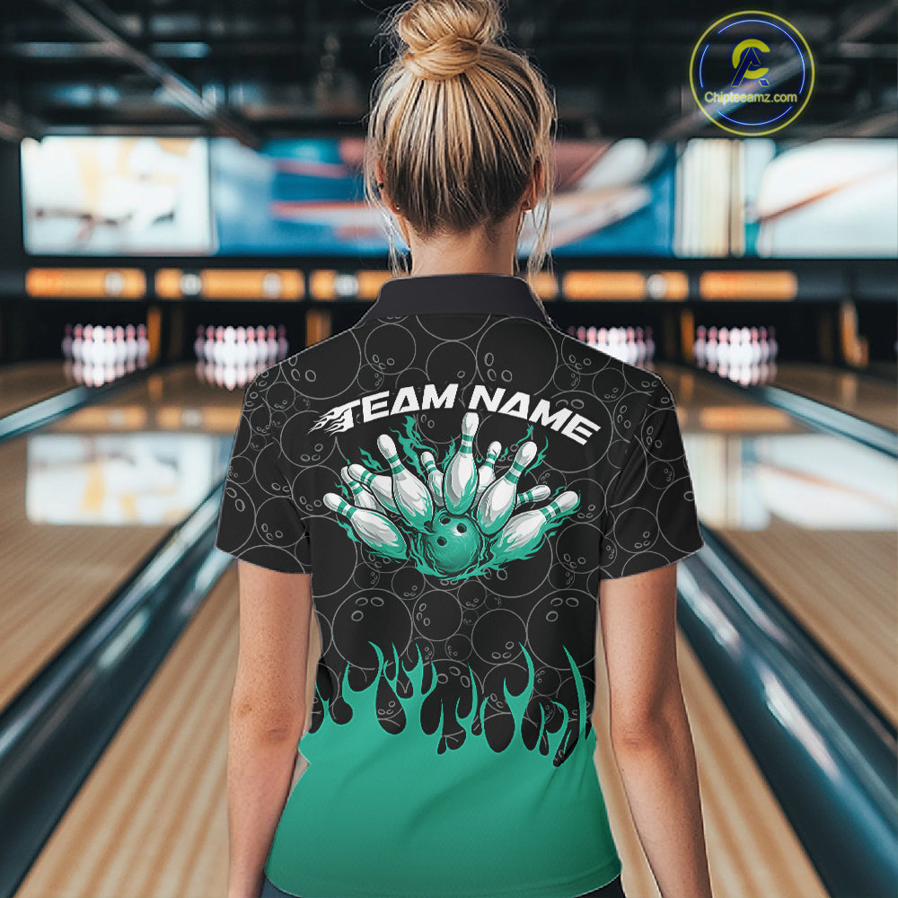 Inside a bowling lane, back view of a female model wearing a black bowling quarter-zip shirt with vibrant turquoise flames, featuring flaming bowling ball action artwork.