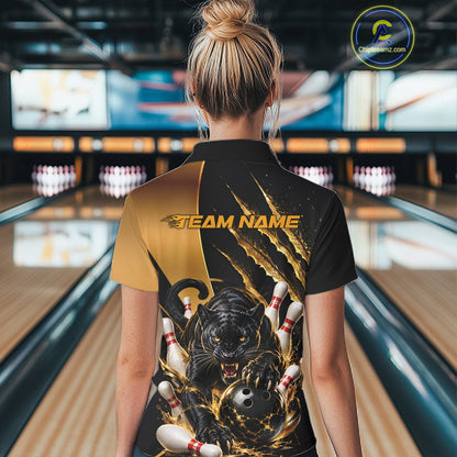 A woman viewed from behind wearing a custom bowling polo shirt with a black and gold design featuring a tiger and bowling pins, set against a blurred bowling alley background.