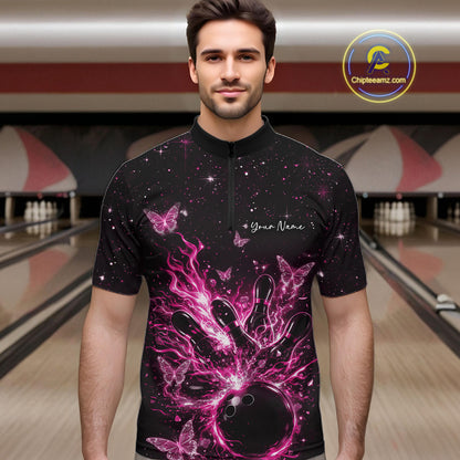 Male model wearing a black and pink bowling quarter-zip shirt at the lane with cosmic flaming strike artwork.