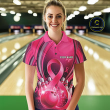 Load image into Gallery viewer, Female model wearing a pink and black bowling polo with breast cancer awareness ribbons and bowling artwork, front view inside a bowling alley